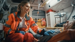 Female EMS professional comforting a man