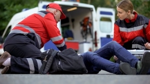 EMS team helping a patient on the road