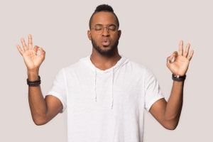 Stressed African-American man in a meditation pose