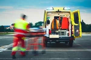 Blurred image of EMS professionals transporting a patient