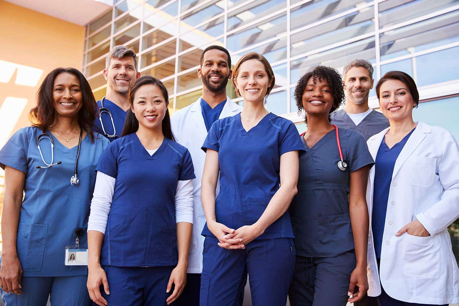 Diverse group of medical professionals standing outside